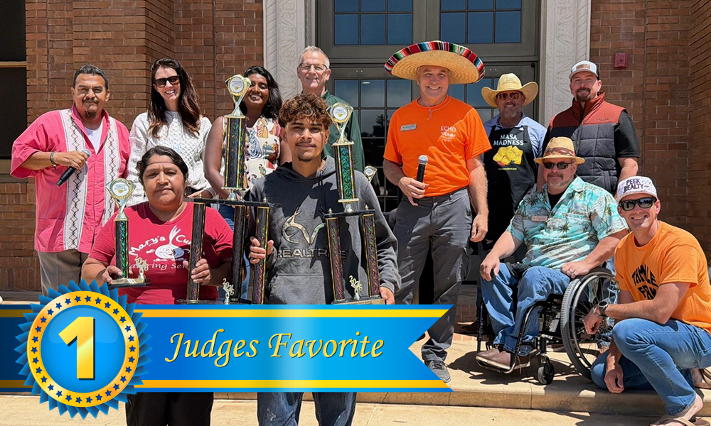 Group photo at the 2026 Tamale Festival showing the Best Overall Tamale winners, Mary’s Cuisine Catering from San Luis Obispo, standing on the steps of Atascadero City Hall and holding their trophies, with event judges posed behind them.